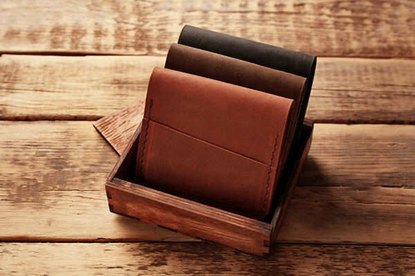 three brown wallets